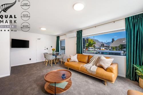 a living room with a couch and a table at Luxe Suites & Apartments in Queenstown