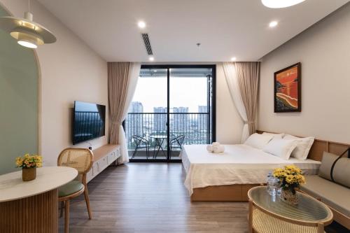 a hotel room with a bed and a balcony at La Vie Eco in HÆ°ng YÃªn