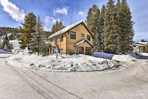 a house with a pile of snow in front of it at Mountainside Winter Park Ski Home with Hot Tub in Winter Park