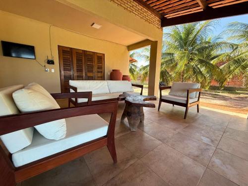 a room with a bed and a chair and a table at MHV Milagres - Casa Mar, Refugio a beira mar na Paradisíaca praia da enseada do toque in São Miguel dos Milagres