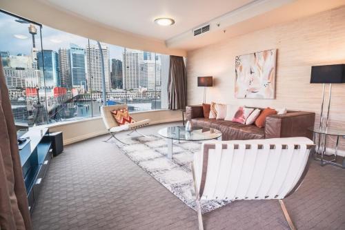 a living room with a couch and a table at Luxury bay view Darling Harbour Free Parking in Sydney