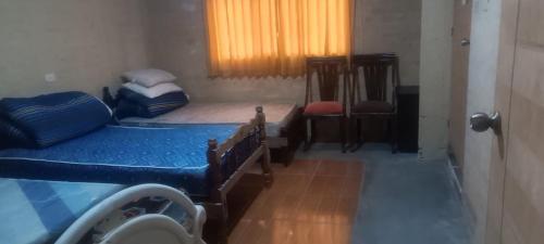 a bedroom with two twin beds and a window at Cozy Rural House in Apata - Jauja 