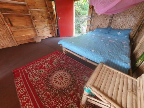 an aerial view of a bedroom with a bed and a rug at BiCa Eco-Village in Pokhara