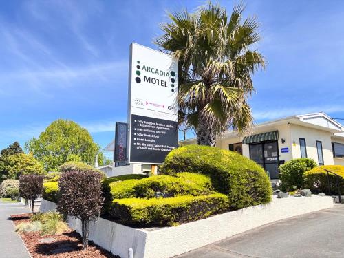 a sign for a motel in front of a building at Arcadia Motel in Nelson