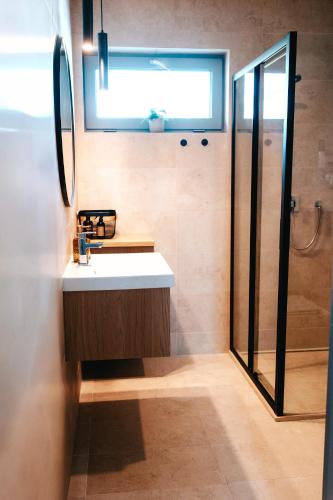 a bathroom with a sink and a shower at M&D Appartments in Valtice