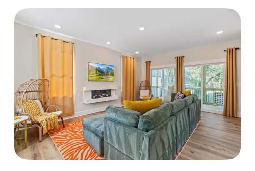 a living room with a couch and a fireplace at Brand New 3 Bed 3 Bath Modern Home in Downtown in Raleigh