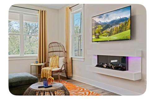 a living room with a tv on a wall at Brand New 3 Bed 3 Bath Modern Home in Downtown in Raleigh