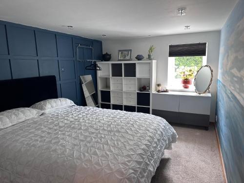 a bedroom with a large bed and a window at Peaceful and Stylish Garden Flat Close to Transport and City Centre in Glasgow