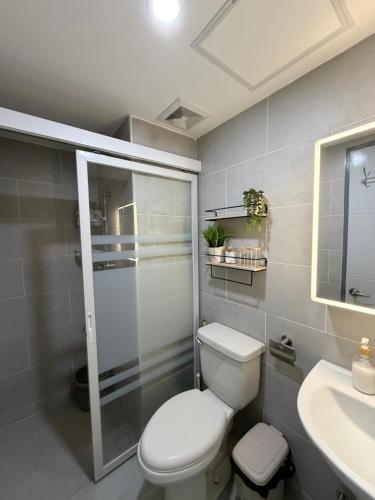 a bathroom with a toilet and a sink at Cliffiens Cozy Space in Sampong