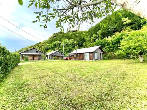 a group of cottages in a field of grass at Gubo Satoyama Suite Lodge & Camp - Vacation STAY 39508v in Katsuura