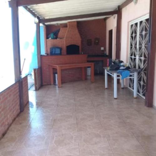 a large living room with a table and a fireplace at Mansão da sull in São Paulo