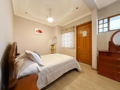 Un dormitorio con una cama y una cómoda y una ventana. en Hotel Ruth Boutique Cuenca by Lauza, en Cuenca
