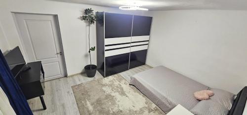 a small room with a bed and a door at Urban Holiday Retreat in Craiova