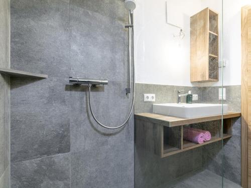 a bathroom with a sink and a shower at Heualm in Hopfgarten im Brixental