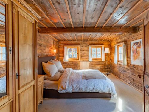 a bedroom with a bed in a wooden cabin at Alte Grafenmühle in Hopfgarten im Brixental