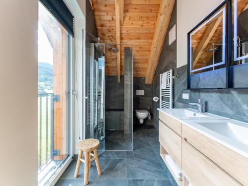 a bathroom with a sink and a toilet and a window at Mountain Chalet Alpinchique in Sankt Lorenzen ob Murau