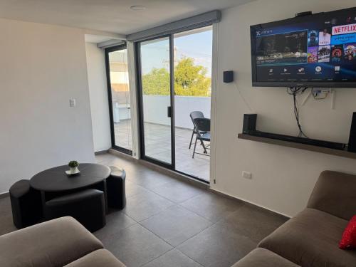 a living room with a couch and a flat screen tv at Hogar Periférico Sur in Lomas de Angelopolis