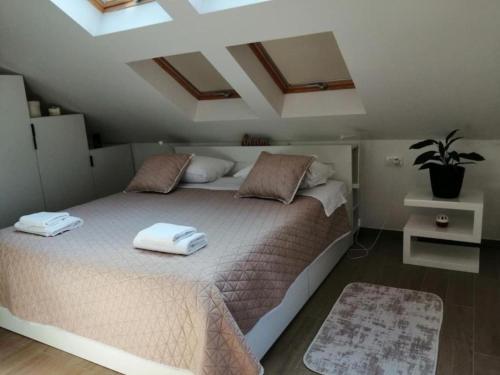 a bedroom with a bed with two towels on it at House Serenity with Pool in Vrgorac