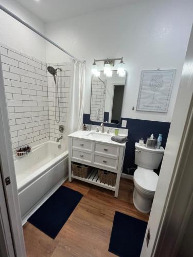 a bathroom with a tub and a sink and a toilet at GFU neighborhood and Oregon Wine Country studio in Newberg