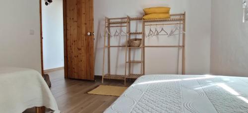 a bedroom with a bed and a wooden floor at Varandas do Vale Furnazinhas in Castro Marim