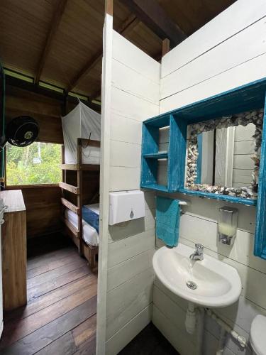 a bathroom with a sink and a bunk bed at Majagua in Bahía Solano
