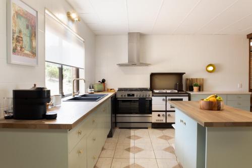 a kitchen with a sink and a stove top oven at Tranquil mountain escape with bushland views in Mount Tamborine