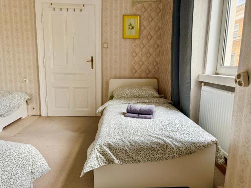 a small bedroom with two beds and a window at Spacious Classical Style Apartment in Vienna