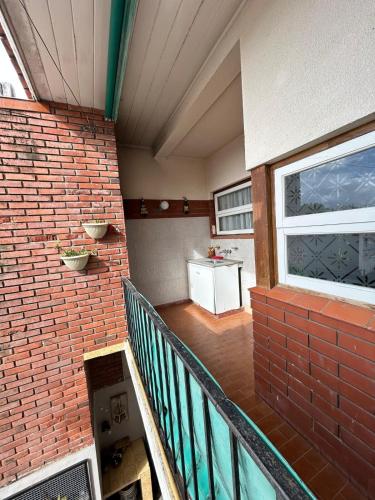 a balcony of a building with a brick wall at MIRAMAR departamento casa in Miramar