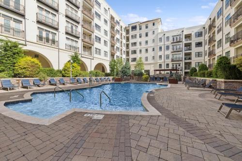 a pool in the courtyard of a apartment building at Kasa Village District Raleigh in Raleigh
