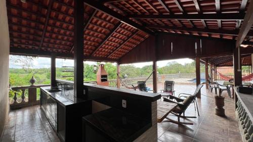 a large room with a table and chairs on a deck at Your private paradise 4 suites in Hidrolândia GO in Hidrolândia