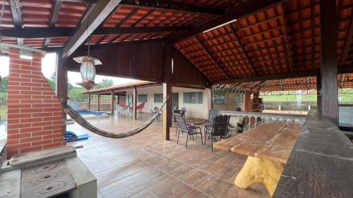 an outdoor patio with a wooden table and chairs at Your private paradise 4 suites in Hidrolândia GO in Hidrolândia