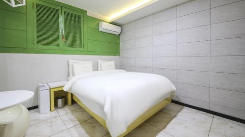 a small bedroom with a bed and a sink at Jeonju COJAJA in Jeonju