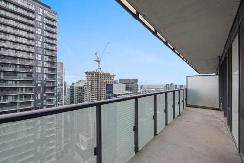 a balcony with a view of a city at Chic 1-Bedroom Downtown Toronto Getaway in Toronto