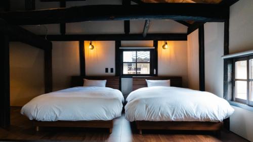 Ένα ή περισσότερα κρεβάτια σε δωμάτιο στο nipponia白山白峰奥山人の里せんにょも棟