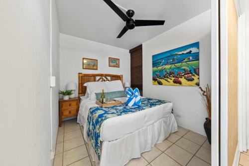a bedroom with a bed and a ceiling fan at Kahana Reef 201 · KR 201 OceanFront 1BD Condo w Ocean Views Pool in Kahana