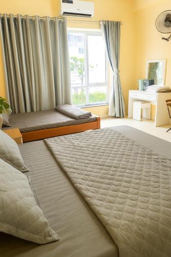 a bedroom with two beds and a window at Nhật Minh Motel Hải Phòng in Hai Phong