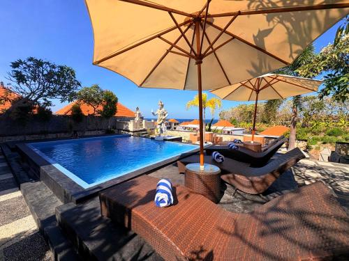 a swimming pool with an umbrella and a chair at Pooja Ocean View Cottage in Nusa Penida