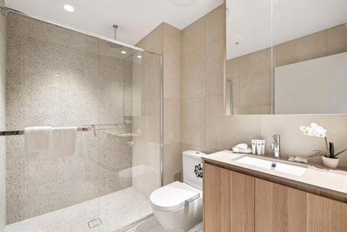a bathroom with a shower and a toilet and a sink at 409 at CODA - City Convenience Meets Coastal Ease in Coffs Harbour