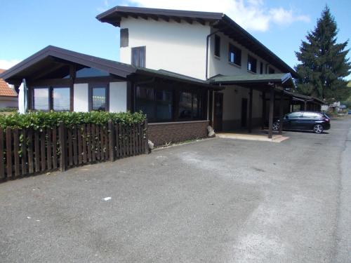 a building with a car parked in front of it at AgriHotel Papaya in San Pietro Apostolo