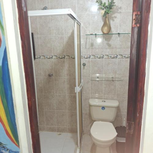 a bathroom with a toilet and a shower at Donde Mire in Puerto Colombia