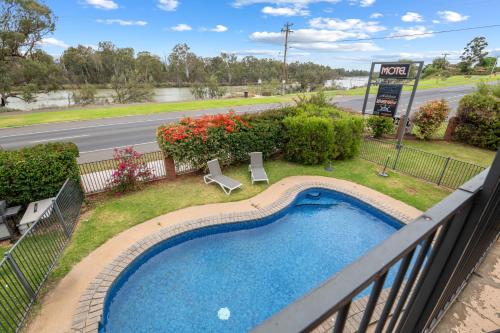 a balcony with a swimming pool and a road at Mildura Riverview Motel in Mildura