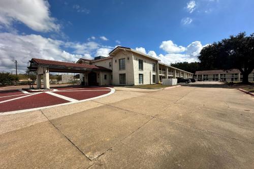 an empty parking lot in front of a building at Baymont by Wyndham Nacogdoches Near University in Nacogdoches
