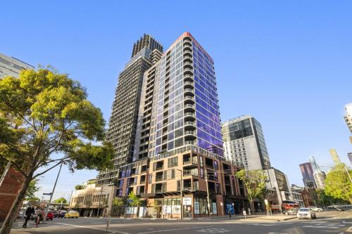 a tall building on a street in a city at Elegant 2-Bed with Superb Views & Amenities in Melbourne
