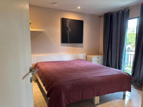 a bedroom with a bed and a tv on the wall at Room in The Title Rawai Phase 1,2, Condo in Rawai, Room in Rawai, Room in The Title Rawai in Rawai Beach