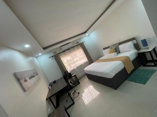 a bedroom with a large bed and a window at Better value stay in Lusaka
