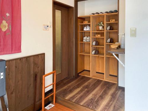 a hallway with a door and a wooden shelf at 松本はなれ Matsumoto HANARE - Japanese style private bedroom Guest hause in Matsumoto