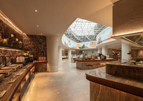 a restaurant with a large kitchen with a glass ceiling at Mercure Lanzhou Dongfanghong Square Hotel in Lanzhou
