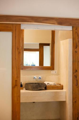 a bathroom with a sink and a mirror at Nativo Lombok Hotel in Kuta Lombok