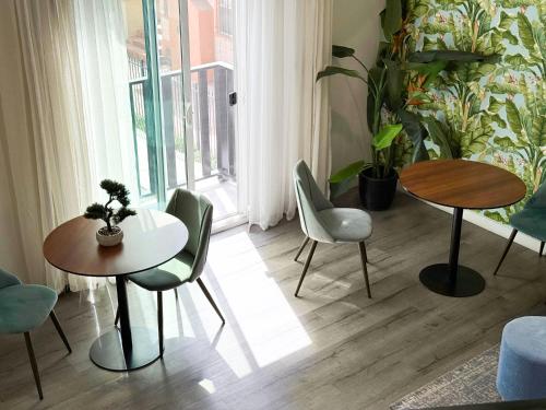 a room with two tables and chairs and a window at Forty First Place - Boutique Hostel in Los Angeles