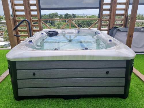 a hot tub sitting on the grass in a yard at ICHA Apartments in Suva